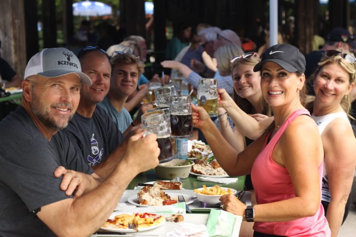 a group of people sitting at a table with food