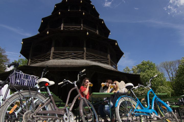 a group of people standing around a motorcycle in front of a building