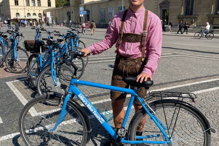 a woman standing in front of a bicycle