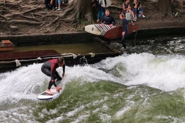 a man riding a wave on a surfboard in the water