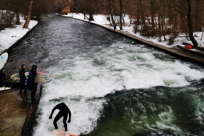 a man riding a wave on a surfboard