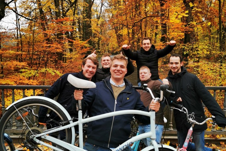 a group of people with bicycles posing for the camera