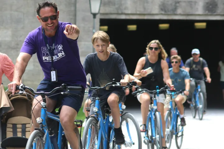 a person riding on the back of a bicycle