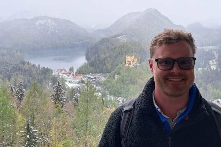 a man standing in front of a mountain