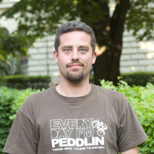 12 a man posing for a picture