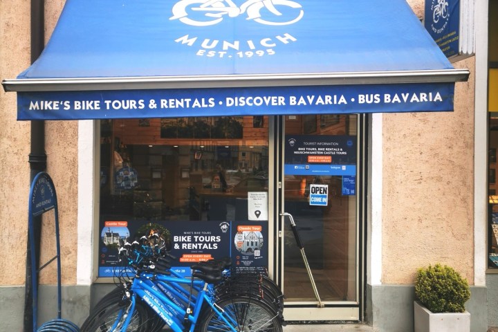 a blue sign sitting on the side of a building