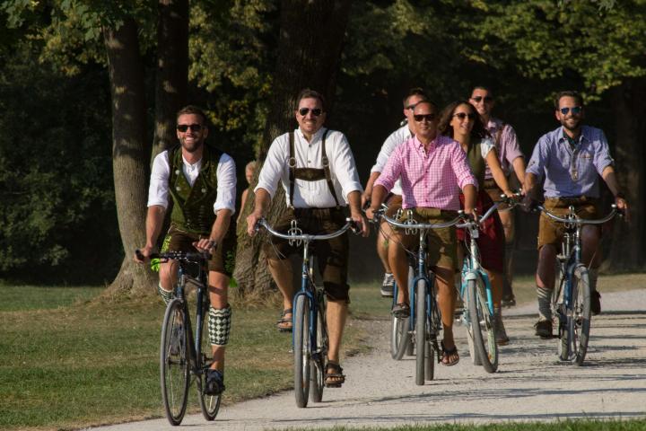 a group of people riding on the back of a bicycle