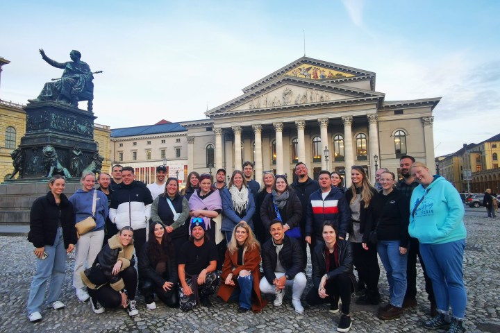 a group of people standing in front of a crowd posing for the camera