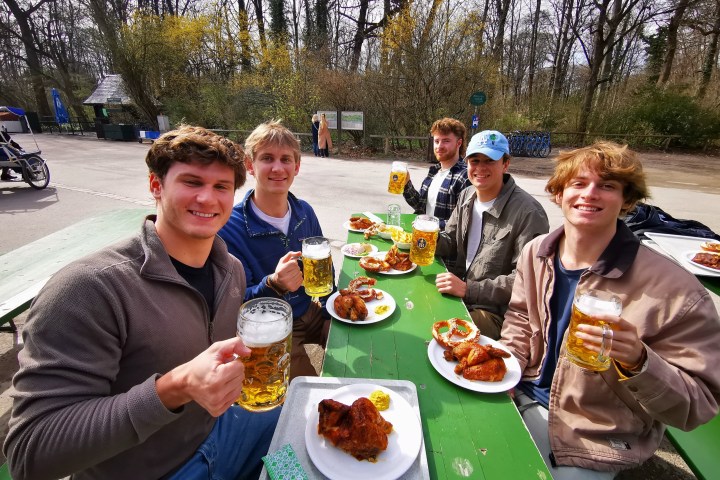 a group of people sitting at a table eating food