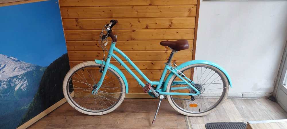 a bicycle parked on the side of a wooden door