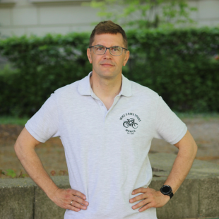 19 a man standing in front of a building